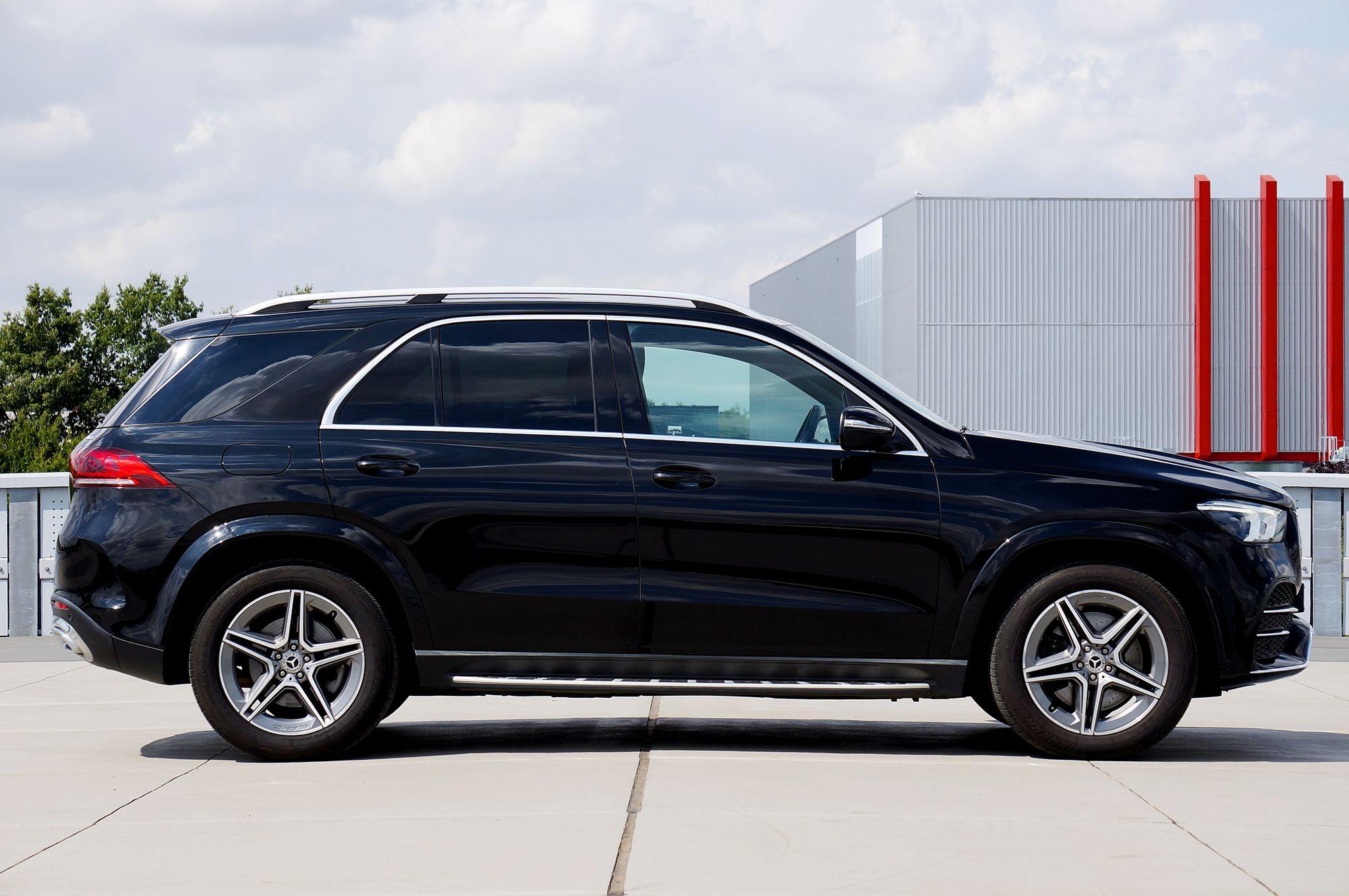 Black Mercedes-Benz GLE in profile, used beside the showroom introduction